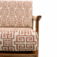 Chair with Greek key patterned cushion on a  neutral background