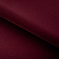 Close-up of a burgundy fabric with a diagonal fold