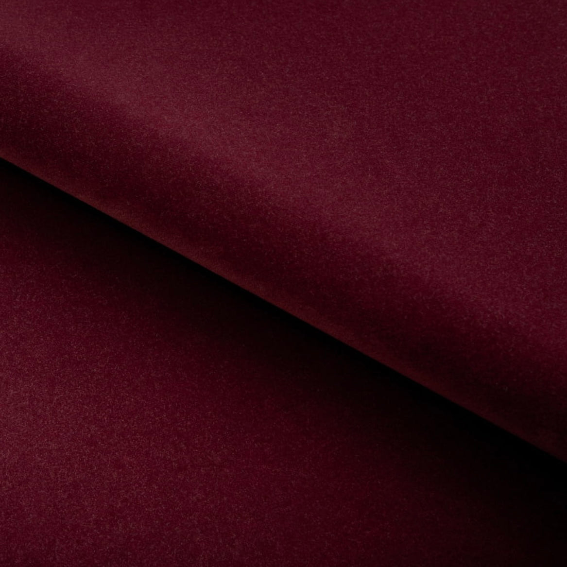 Close-up of a burgundy fabric with a diagonal fold